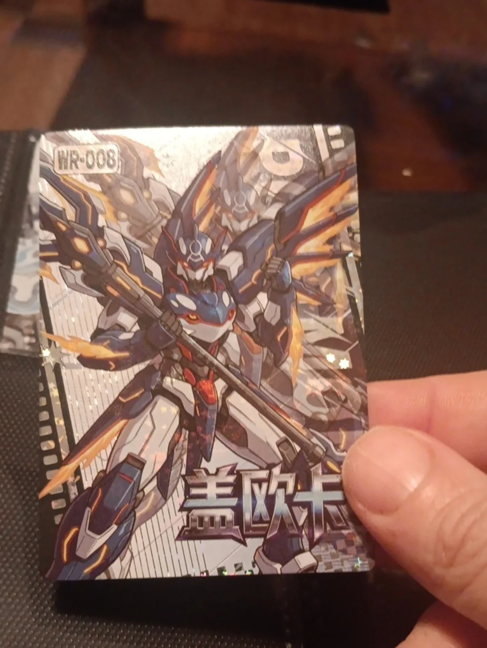 Pokemon Trading Card with Blue, White, Gold and Orange Mech Artwork